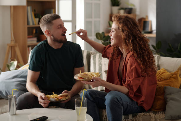 istock Happy couple having fast food at home 2174363906