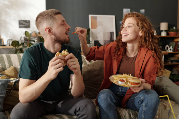 istock Putting french fries in guy mouth 2174363913