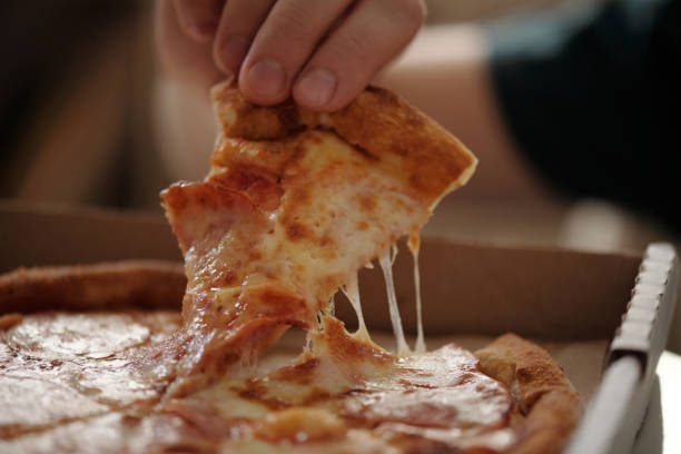 istock Taking slice of tasty pizza from box 2174363918