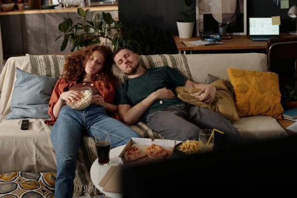 istock Napping on couch in front of tv set 2174363944