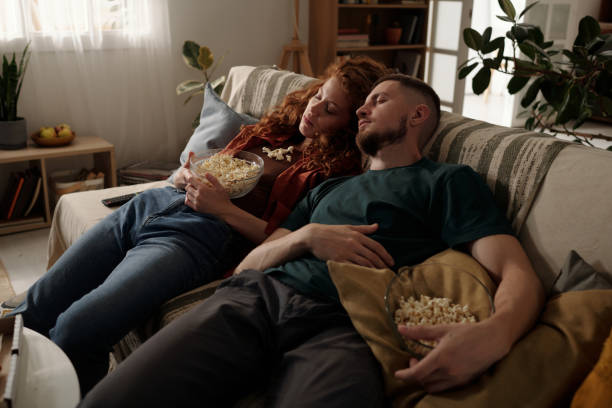 istock Couple sleeping after watching movie 2174363949