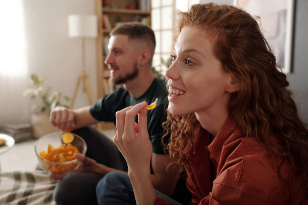 istock Putting crusty potato chips into mouth 2174363975