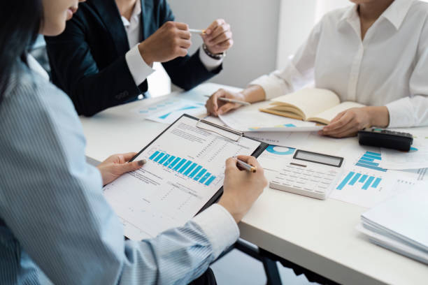 istock Business Meeting with Professionals Analyzing Financial Data and Charts in a Modern Office Setting 2174364896