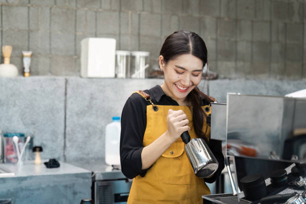 istock Smiling Barista Preparing Coffee with Espresso Machine in Modern Cafe 2174365734