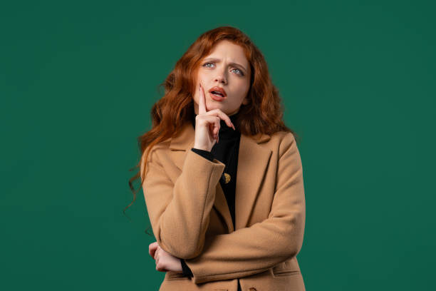 istock Portrait,curious analyzing woman in green studio.Mindful girl searching solution 2174367123