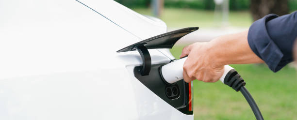 istock Man recharge EV electric vehicle battery from EV charging station. Exalt 2174367789