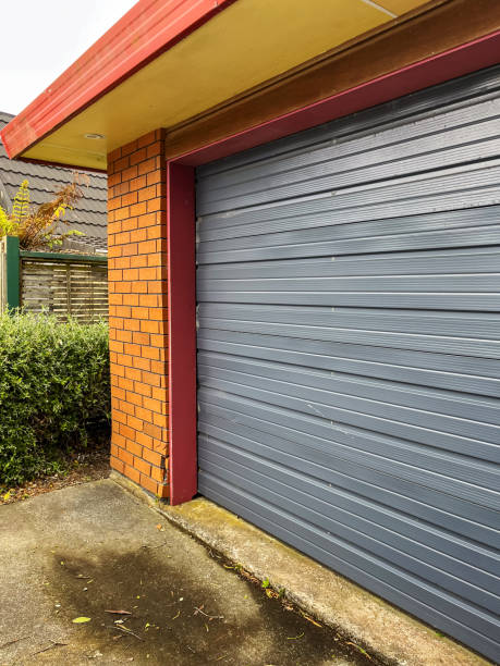 istock A modern garage exterior featuring a red brick wall with a broken corner 2174368722