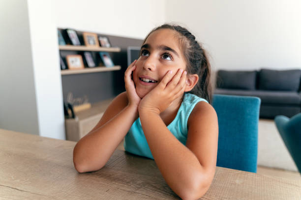istock Little girl's happy thoughts at home 2174368751