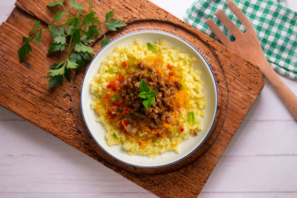 istock Couscous salad with vegetables and minced meat. Top view table with  decoration. 2174372250