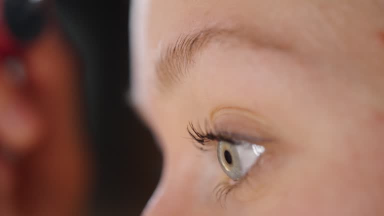 Woman paints her eyebrows with brush in close-up
