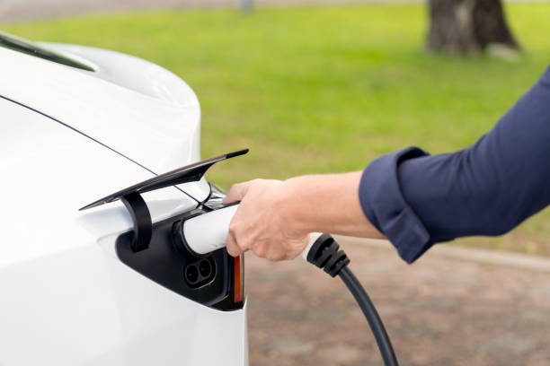 istock Man recharge EV electric vehicle battery from EV charging station. Exalt 2174373884