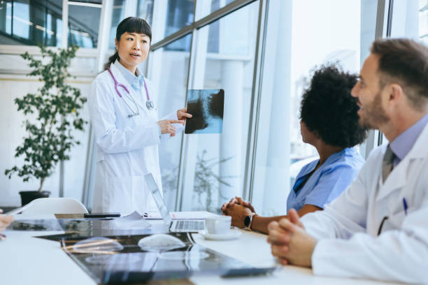 istock Doctor explaining X-ray to colleagues in hospital 2174373946