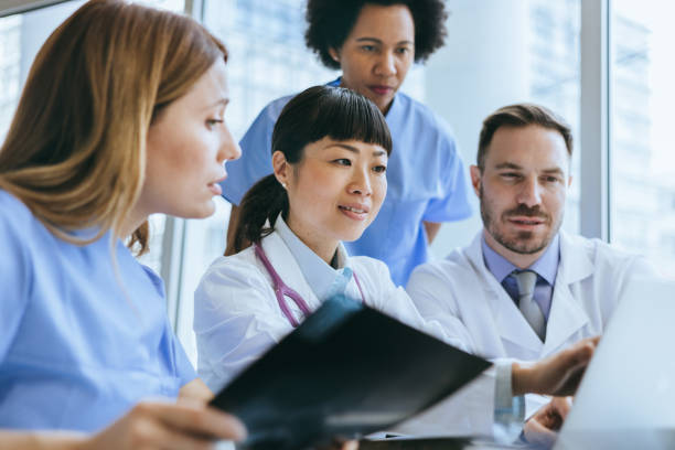 Medical team discussing over a laptop