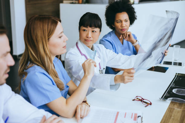 istock Focused team examining X-ray in hospital 2174374506