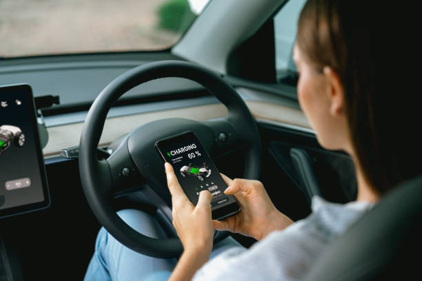 istock Young woman inside the vehicle, checking EV vehicle's application. Exalt 2174375815