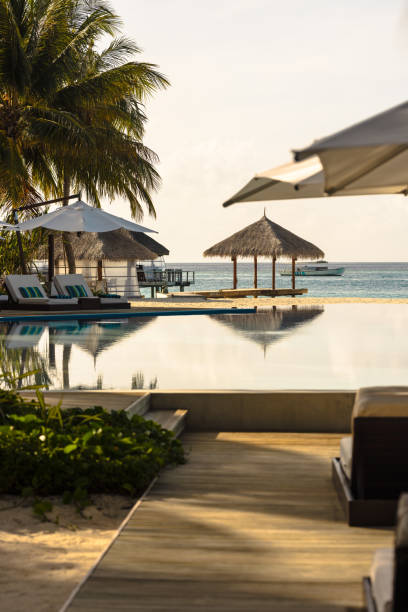 istock Tourist resort pool by the sea at sunset 2174380143
