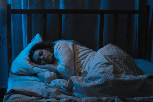istock Insomnia. Woman lying awake in bed at night. 2174380352