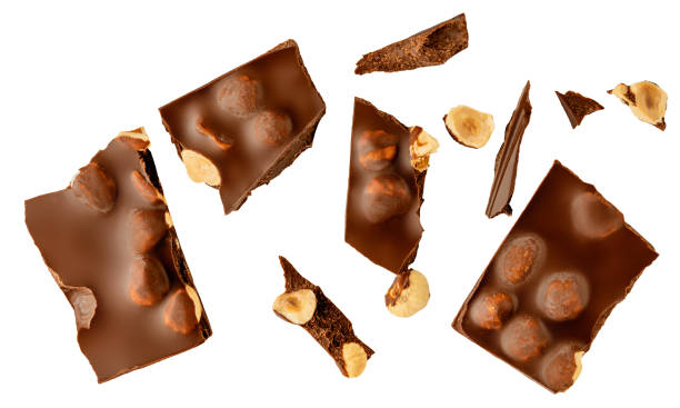 istock  Levitating milk chocolate chunks with hazelnuts isolated on white background. Broken chocolate bar pieces, nuts and cocoa crumbs explotion on white background. Chocolate collection 2174381159