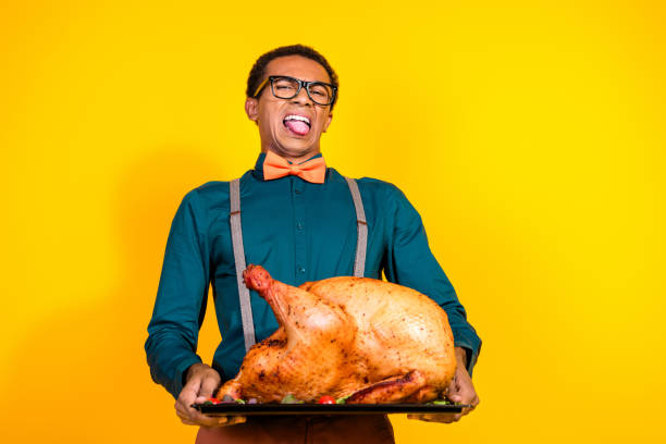 Photo of guy grimacing dont like big heavy turkey for thanksgiving day party isolated yellow color background Photo of guy grimacing dont like big heavy turkey for thanksgiving day party isolated yellow color background. dont eat meat stock pictures, royalty-free photos & images