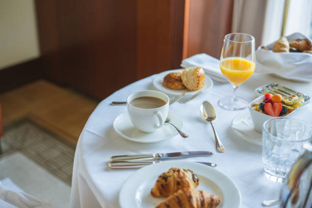 Relaxing hotel room breakfast with coffee, croissants, and fresh fruit