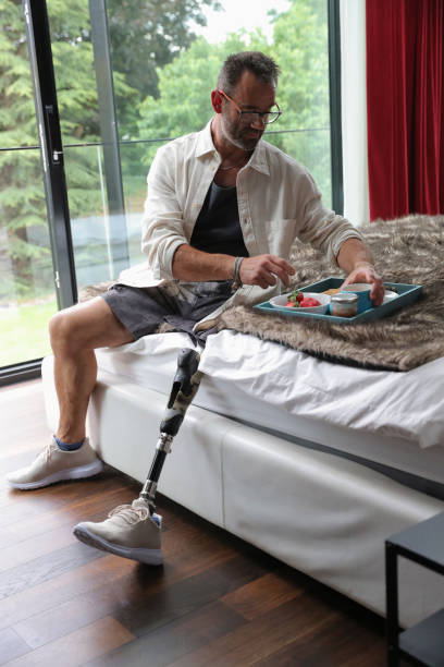 istock Man with artificial limb eating breakfast in bedroom 2174383813