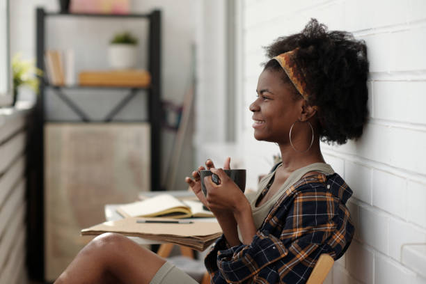 istock Smiling African American Woman Drinking Coffee Indoors 2174384384