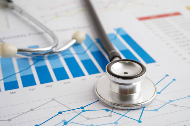 istock Stethoscope on chart or graph paper, Financial, account, statistics and business data medical health. 2174384398