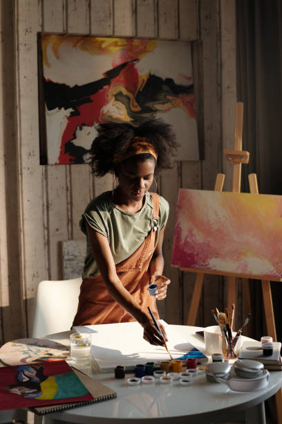 istock Woman Painting Canvas in Art Studio Setting 2174384443