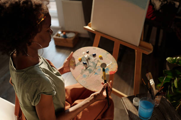 istock Painting Artist Working on Canvas in Studio 2174384470