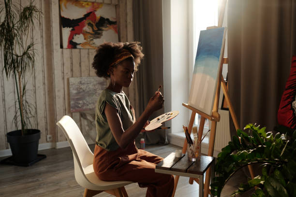istock Painting in Sunlit Art Studio with Creative Relaxation 2174384471
