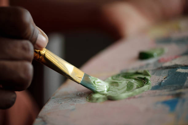 istock Painting Artwork With Brush Dipping into Green Color 2174384476