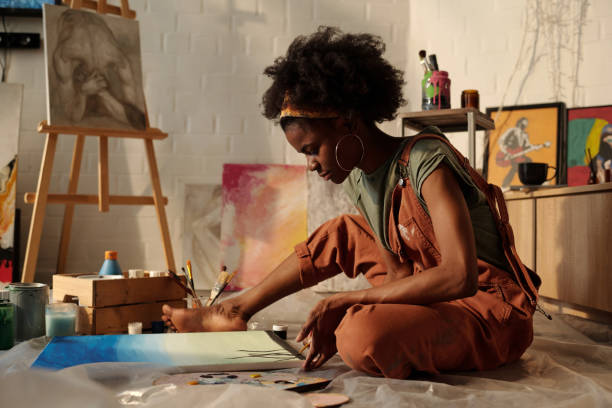 istock Concentrating Artist Painting in Studio Setting 2174384513