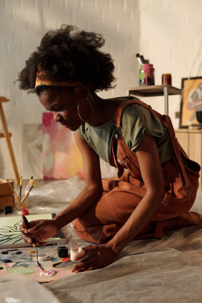 istock Woman Painting in Art Studio With Natural Light 2174384534