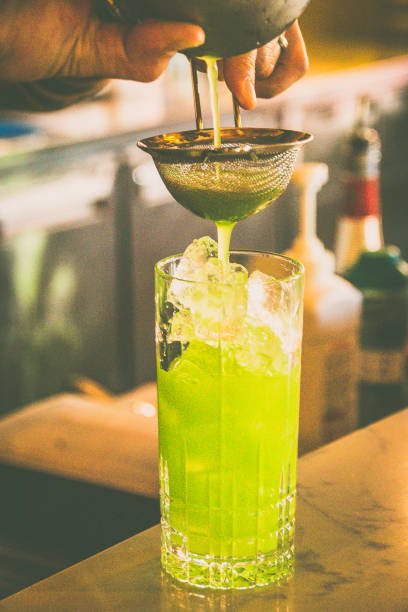 istock batender making a cocktail made from Vodka, Blue Curacao, Lychee Liquer, passion fruit, Lemon, Soda 2174391420