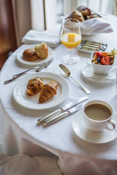 istock Relaxing hotel room breakfast with coffee, croissants, and fresh fruit 2174393307