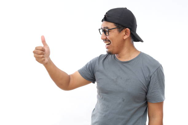 istock Asian man Looking proud, smiling doing thumbs up gesture to the side 2174396434