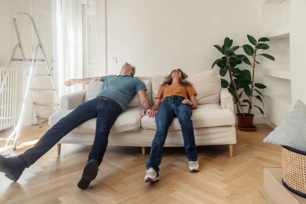istock Man and woman sitting and lying down on sofa 2174397466