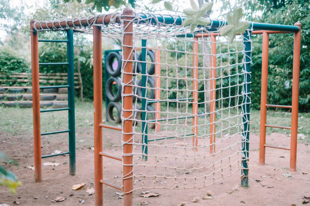 istock Kids' play area with metal frames and installed rope nets, perfect for climbing adventures. 2174401779