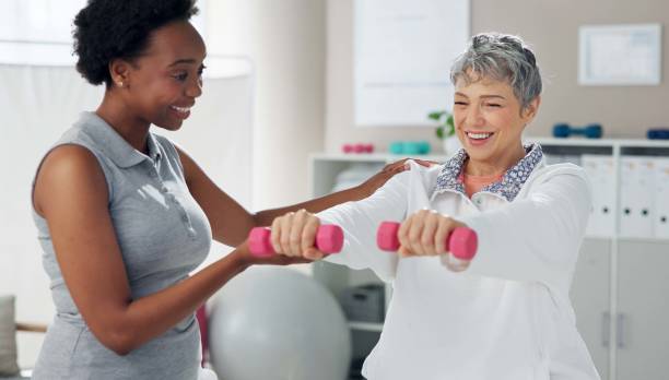 istock Physiotherapy, weights and chiropractor with senior patient for wellness, strength and mobility. Healthcare, clinic and woman with person for physical therapy, rehabilitation and medical support 2174401860