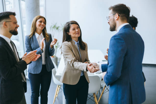 istock Welcoming a new coworker with applause 2174402402