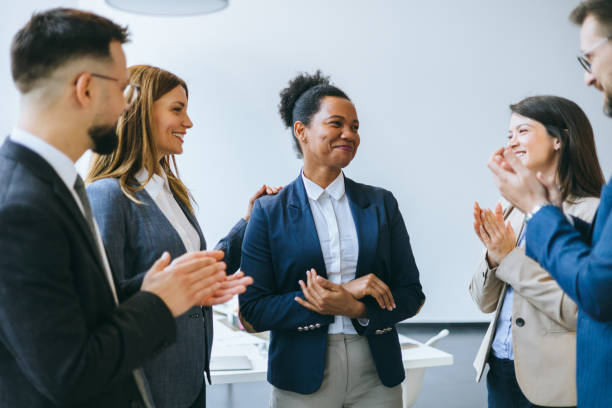 istock Businesswoman enjoying applause from team 2174402407