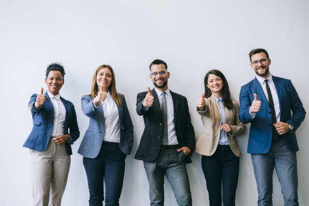 istock Professionals giving thumbs up in office 2174402422