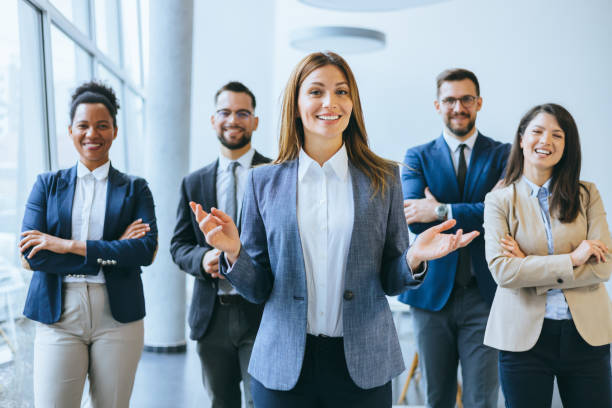 Enthusiastic businesswoman with team behind