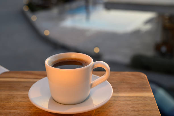 a cup of black Turkish coffee on the balcony overlooking the pool