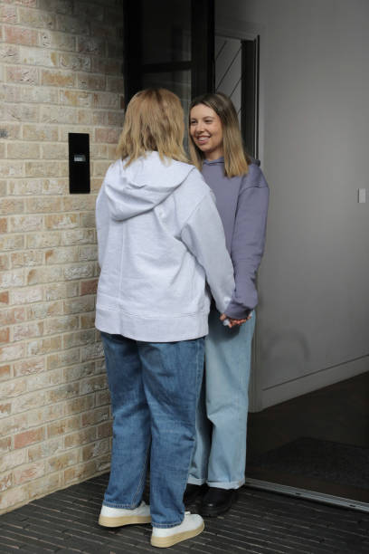 istock Lesbian couple standing outside building 2174406022