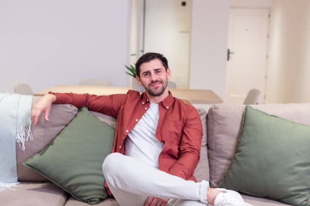 istock Young man relaxing on comfortable sofa at home 2174406354