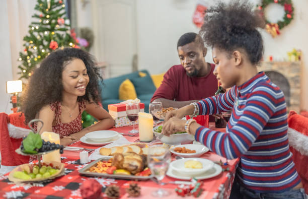istock Black Family Christmas Dinner Celebration 2174408366
