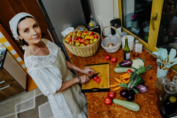 istock A woman is preparing a meal in a cozy kitchen. 2174410887