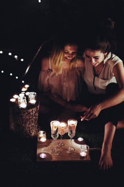 istock Couple with candles resting in night garden 2174411883
