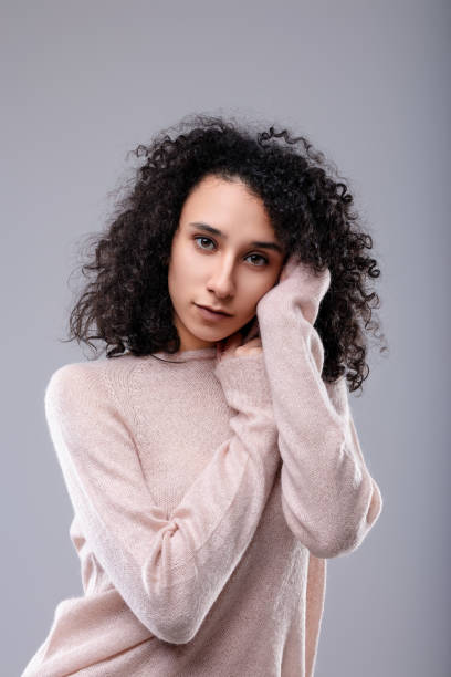 istock Fashion model posing with hands on face and tilted head 2174412991